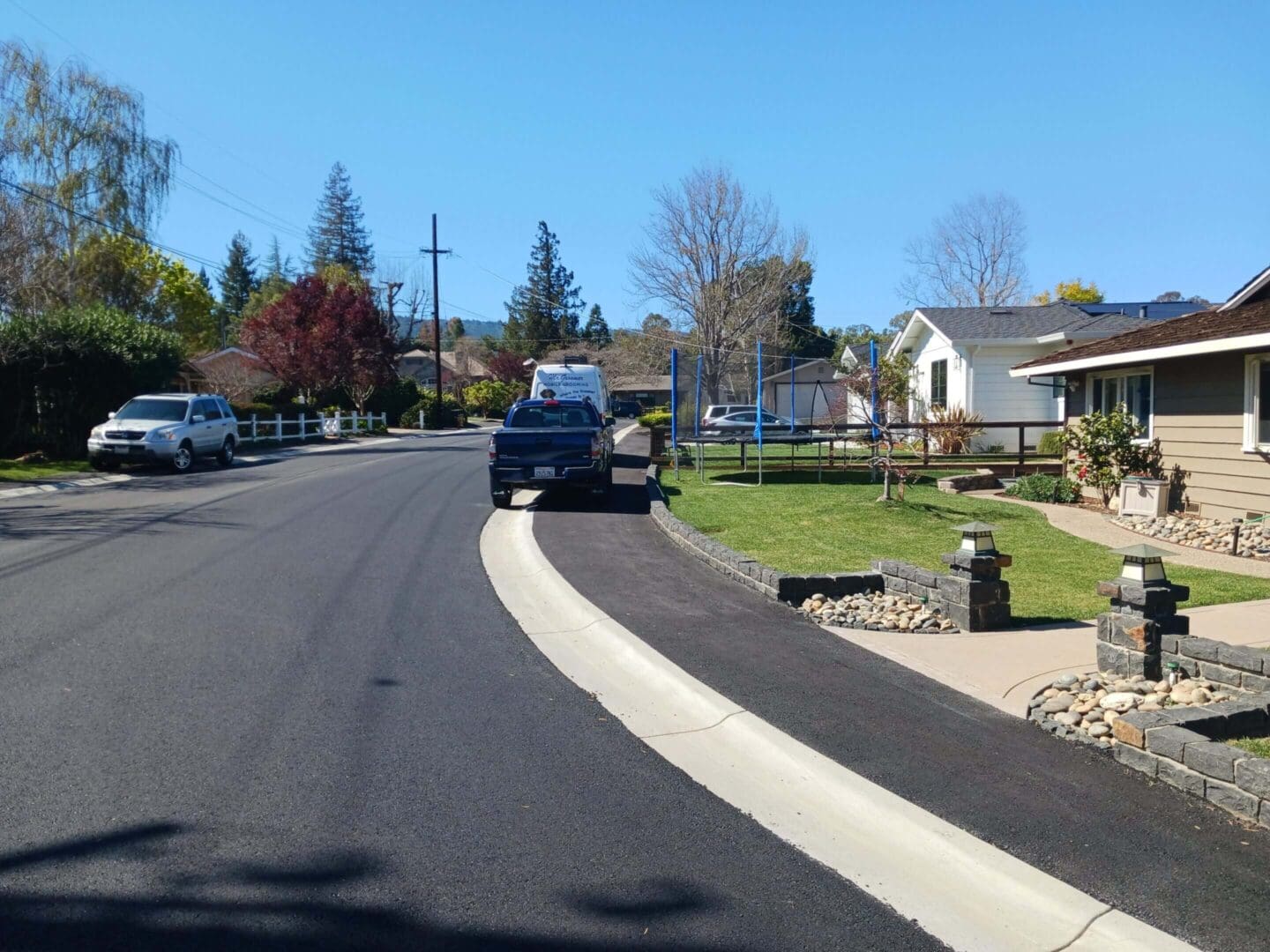 Quiet suburban street with parked cars.