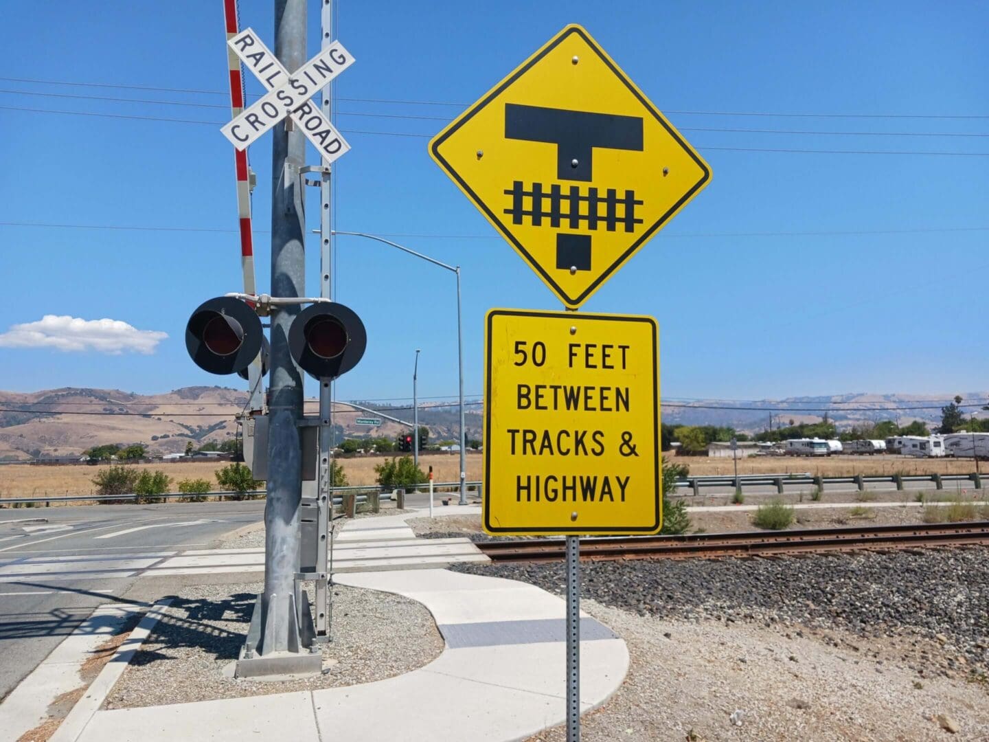 Railroad crossing sign with distance warning.