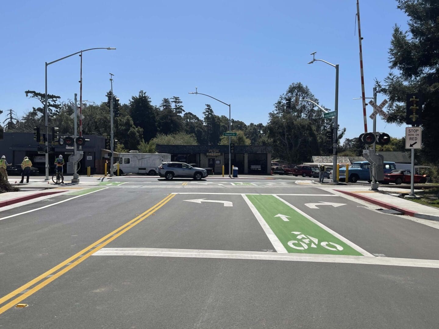 Street intersection with bike lanes and cars.