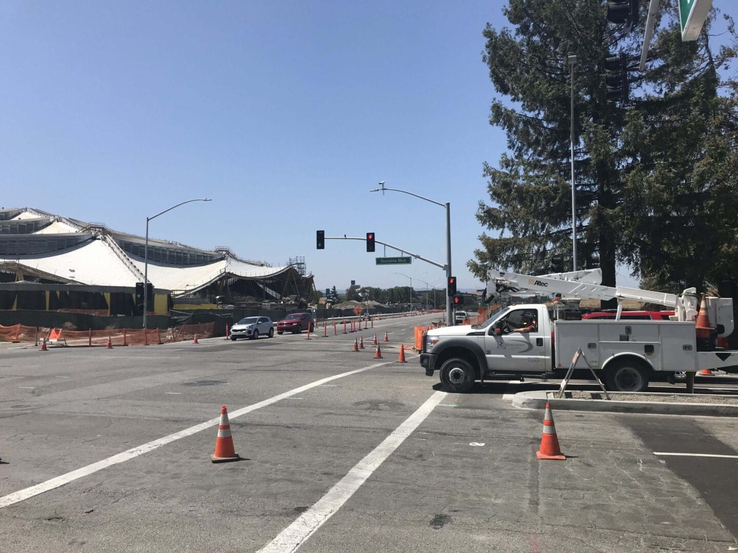 Road construction scene with traffic cones and truck.
