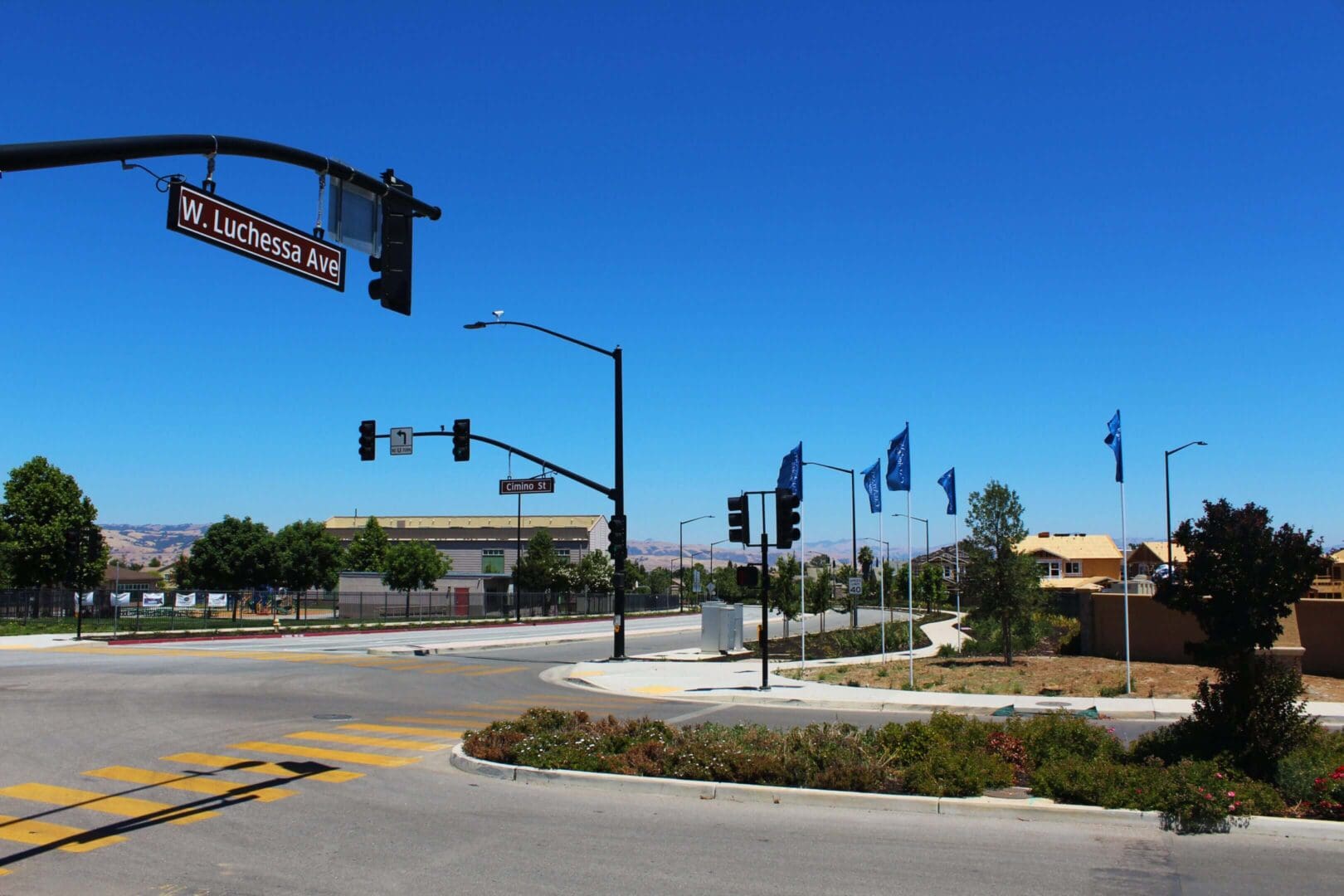Street intersection with traffic lights and flags.