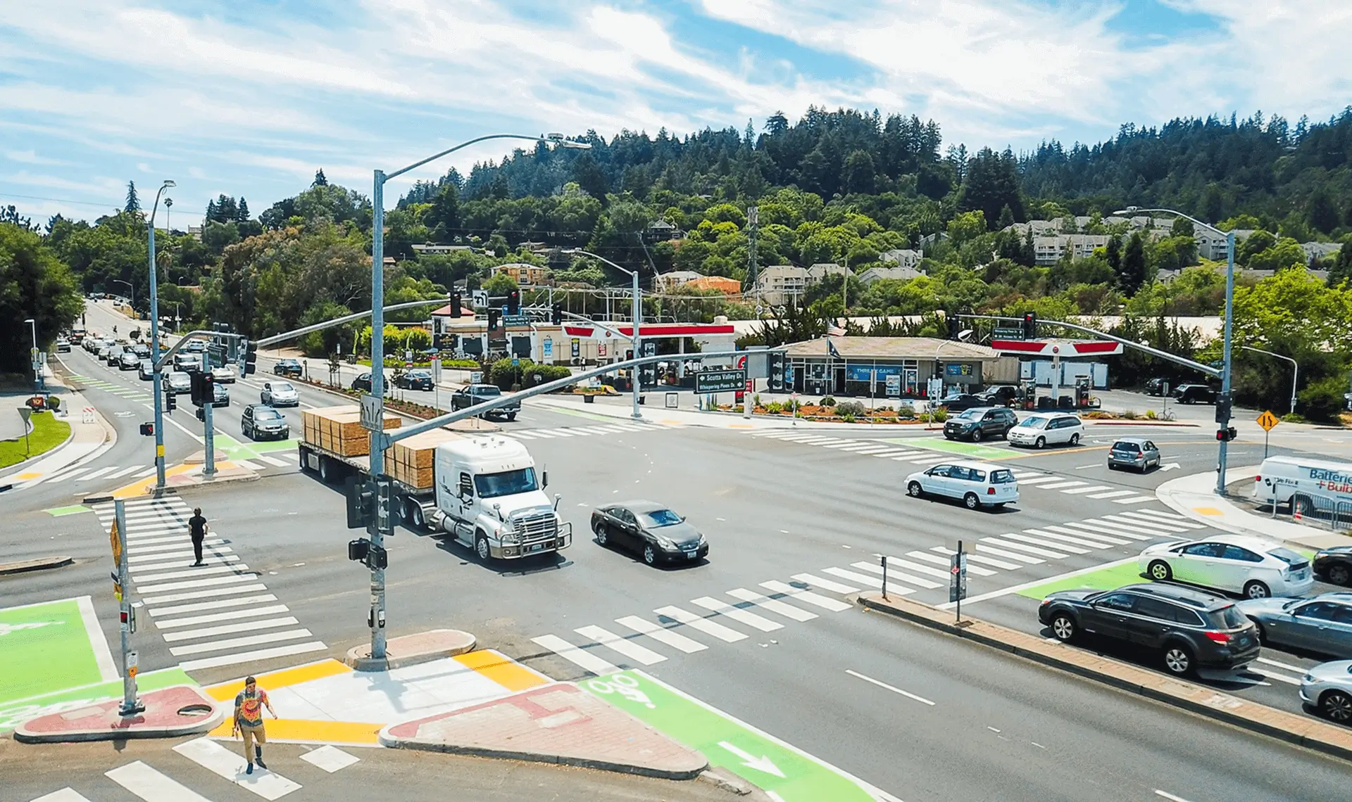 Busy intersection with cars and trucks.